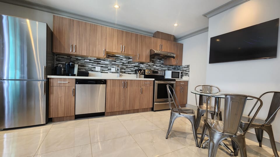 Kitchen with full-size range, induction cooktop, microwave, fridge & dishwasher