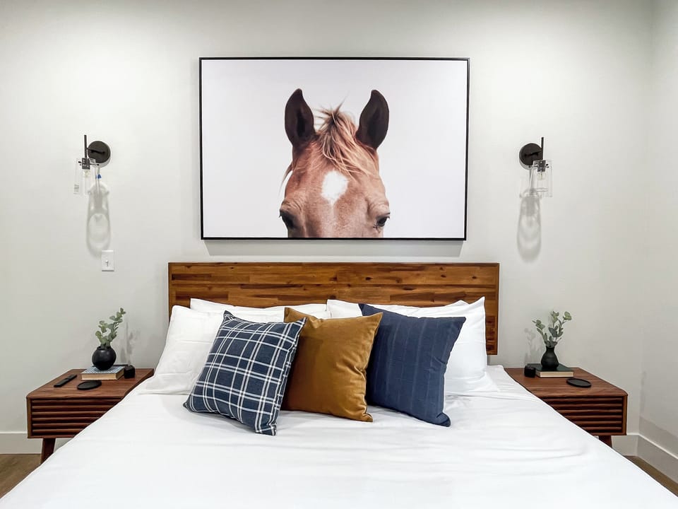 Plush king bed and nightstands in the main level bedroom