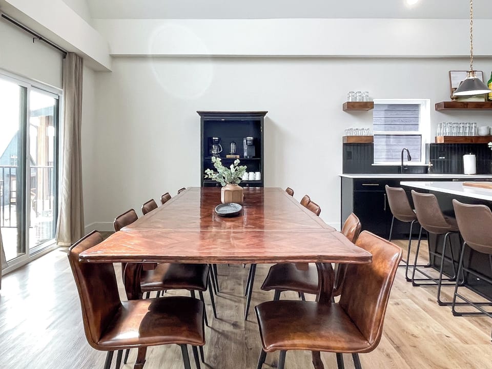 Main level bright and airy dining area with deck access and coffee bar