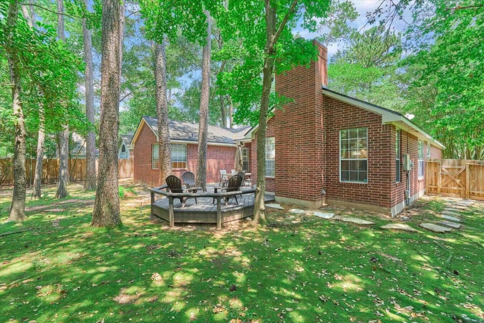 Large shaded backyard with high fence around all sides