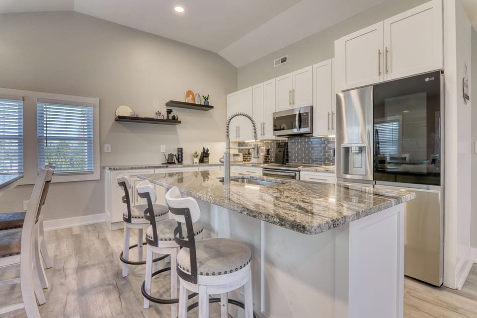 The kitchen island provides additional counter space for serving snacks or meals
