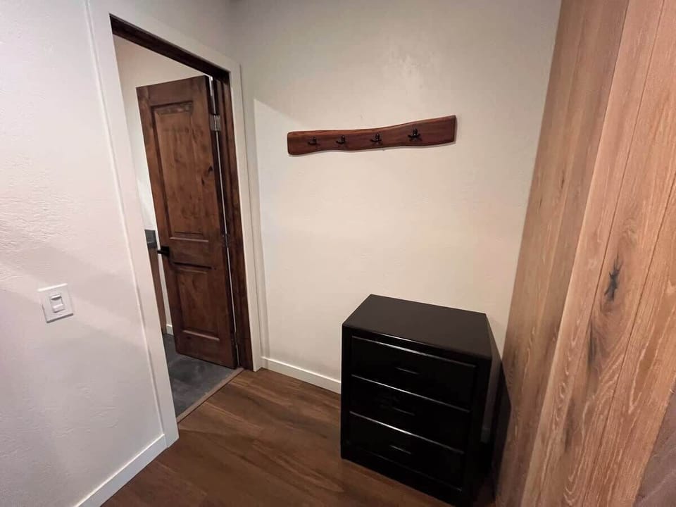 Bunkbed nook dresser and door to full bathroom