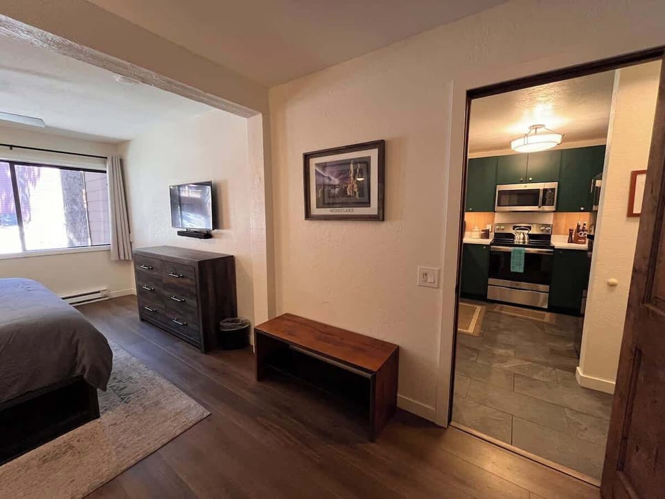 Bedroom with king sized memory foam bed, 40" smart TV, dresser, full closet and attached full bathroom.