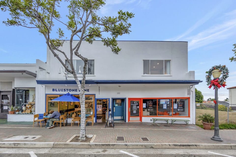 Corner café w/ bright storefront & outdoor seating, adding charm to the neighborhood