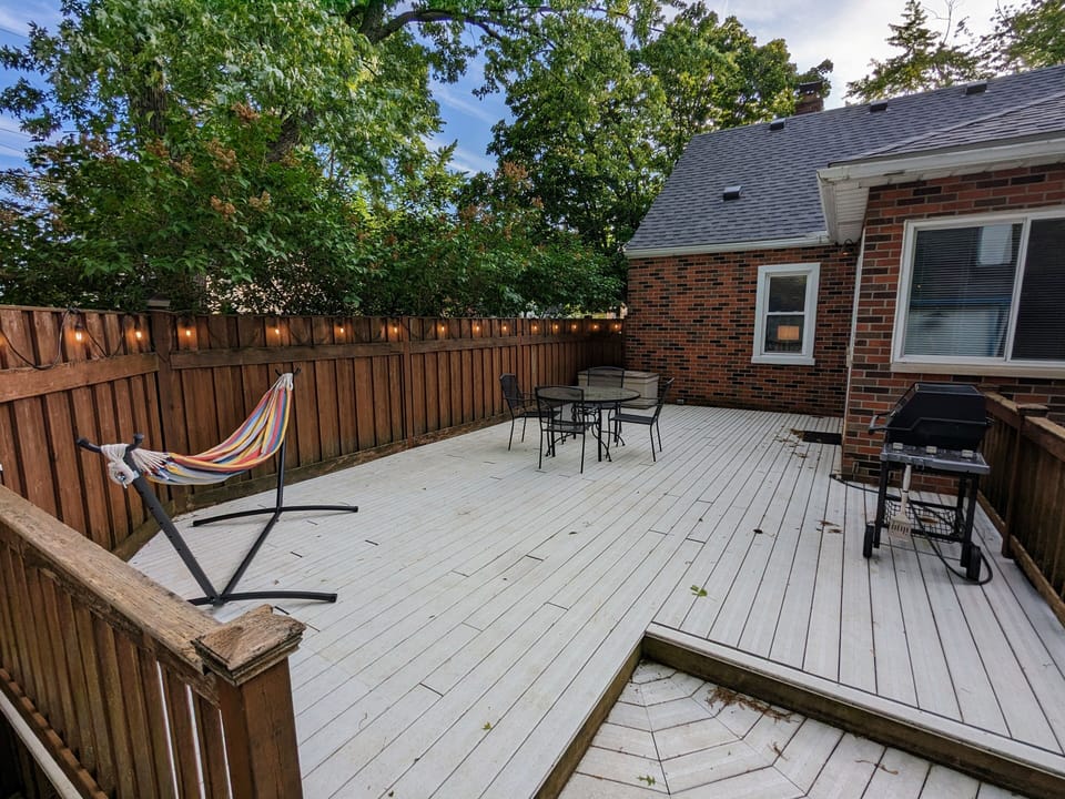 Large private patio featuring a grill, plenty of seating, and a hammock