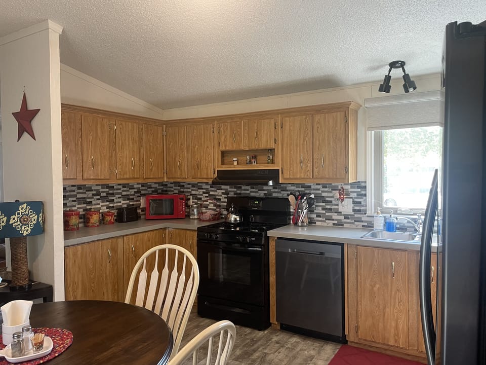 Another corner in the kitchen- microwave, toaster, oven & dishwasher…