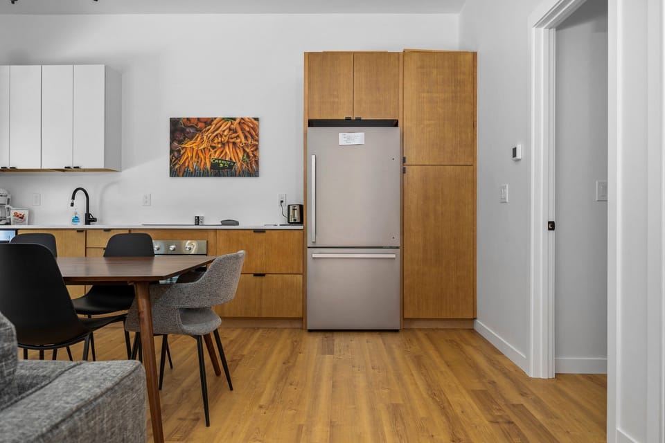 Dining room and kitchen with door to bedroom