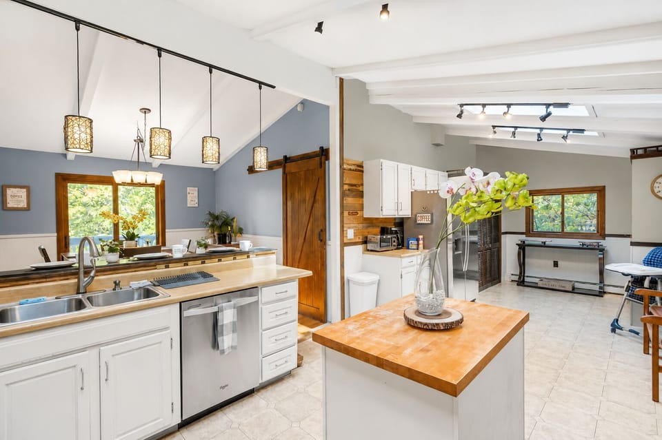 Renovated kitchen with a butcher-block island and skylights
