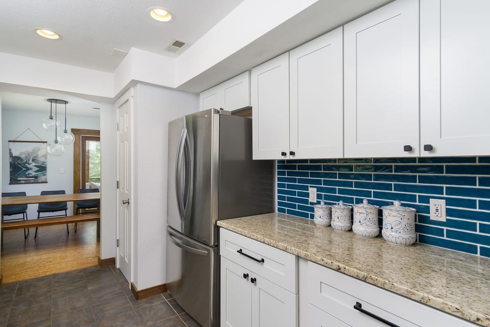 Kitchen with gas range, dishwasher, drip-style coffee maker, and pantry