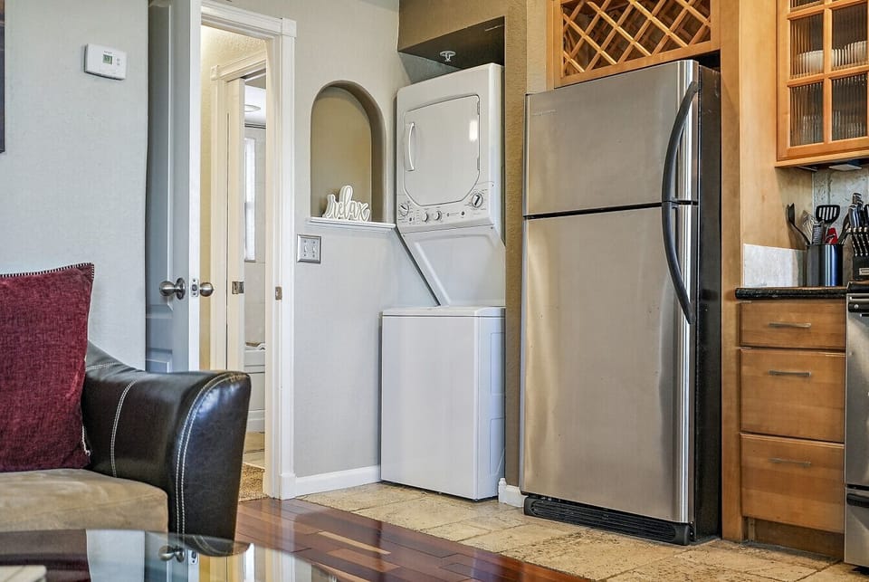 Washer and Dryer with Door Leading to Bedroom