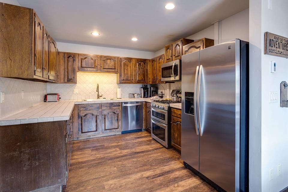 Your fully equipped kitchen features rustic wood cabinets, stainless appliances, and ample counter space for preparing memorable meals together.