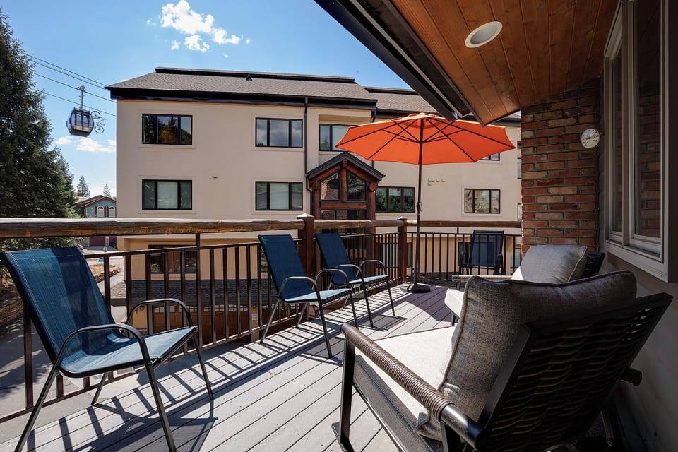 Unwind on your private balcony with comfortable seating and an umbrella for shade, perfect for morning coffee or evening relaxation.