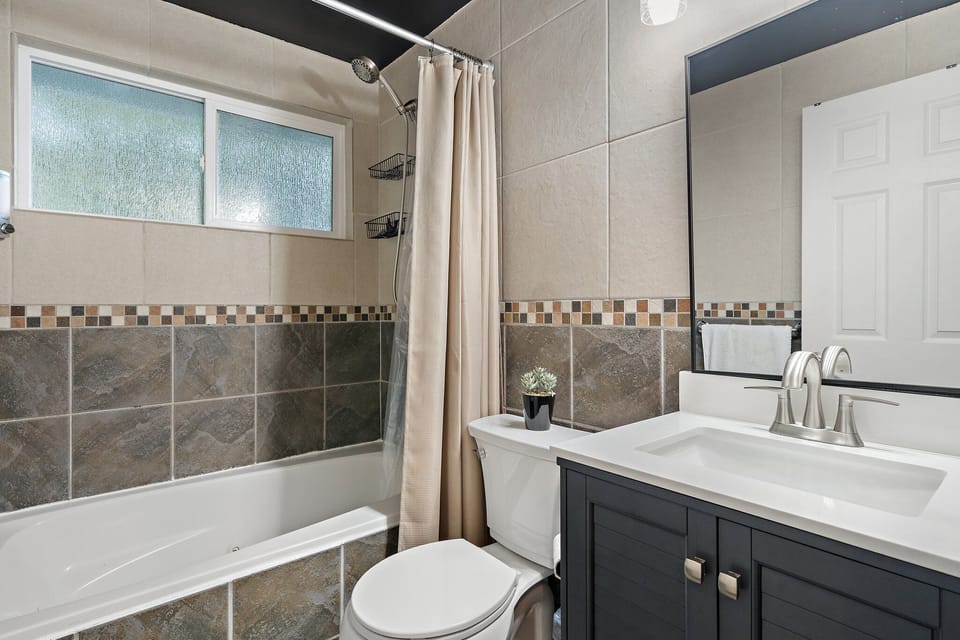 The primary ensuite bathroom with a shower-tub combo.