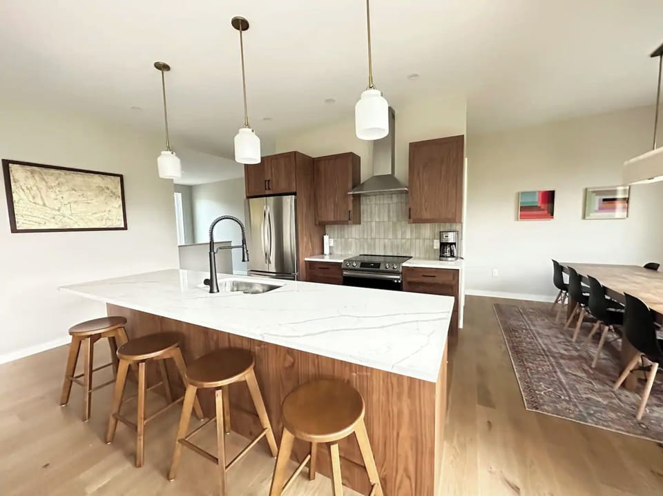 Kitchen island, stools and adjacent dining room