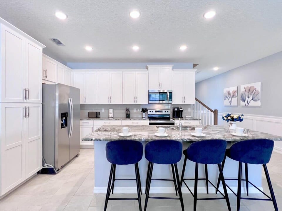 Enjoy the bright open-concept kitchen with stainless steel appliances, plenty of counter space, and a functional layout that keeps everyone connected.