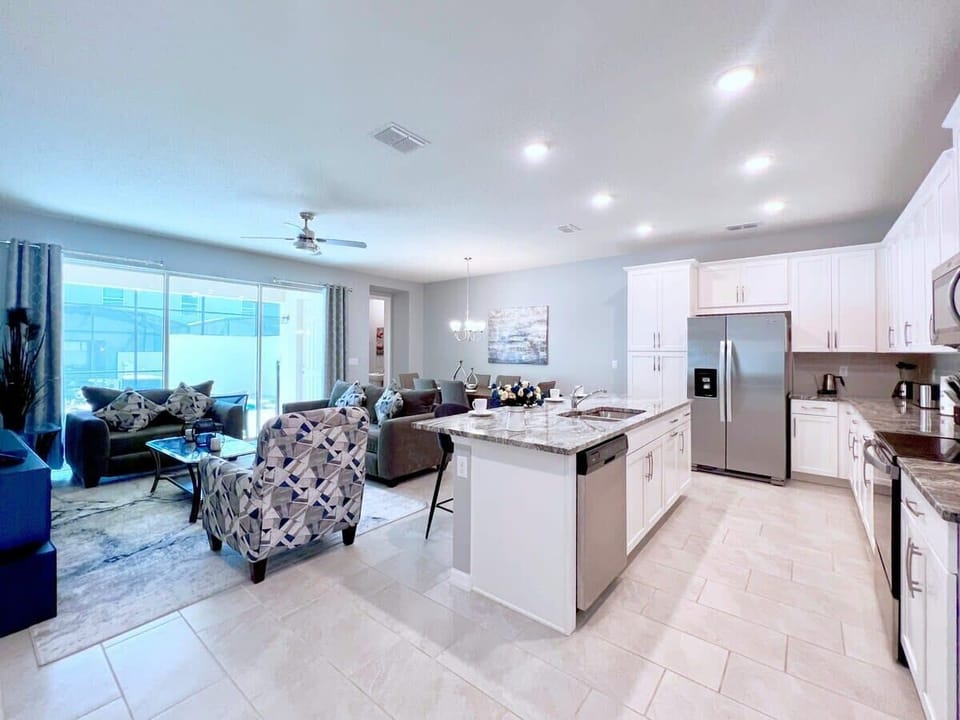 Cook with ease in the open-concept kitchen featuring modern stainless steel appliances, generous workspace, and a layout perfect for gathering with family and friends.
