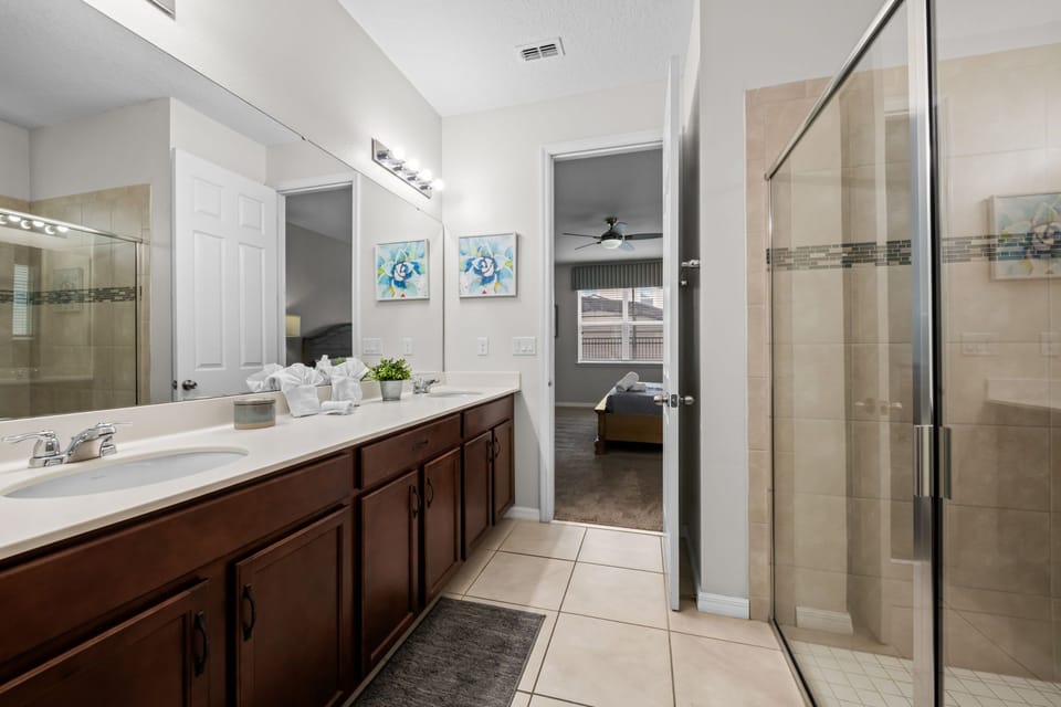 Refresh and recharge in this beautifully appointed full bathroom featuring a spacious double vanity, shower, bright lighting, and stylish finishes for an elevated start and end to your day.