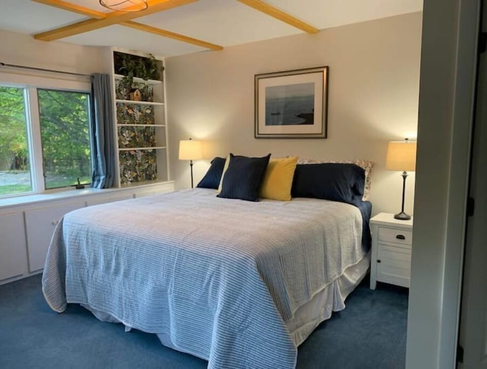 First floor bedroom with king bed and attached bathroom