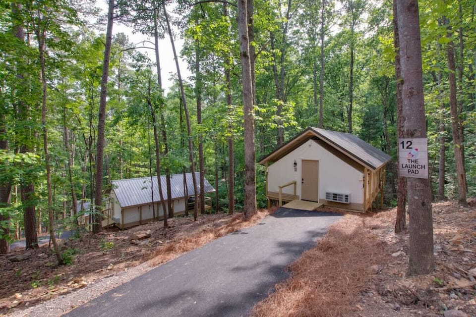Spacious glamping tent featuring a private hot tub, king bed, and scenic views. Experience luxury camping in the heart of North Alabama.