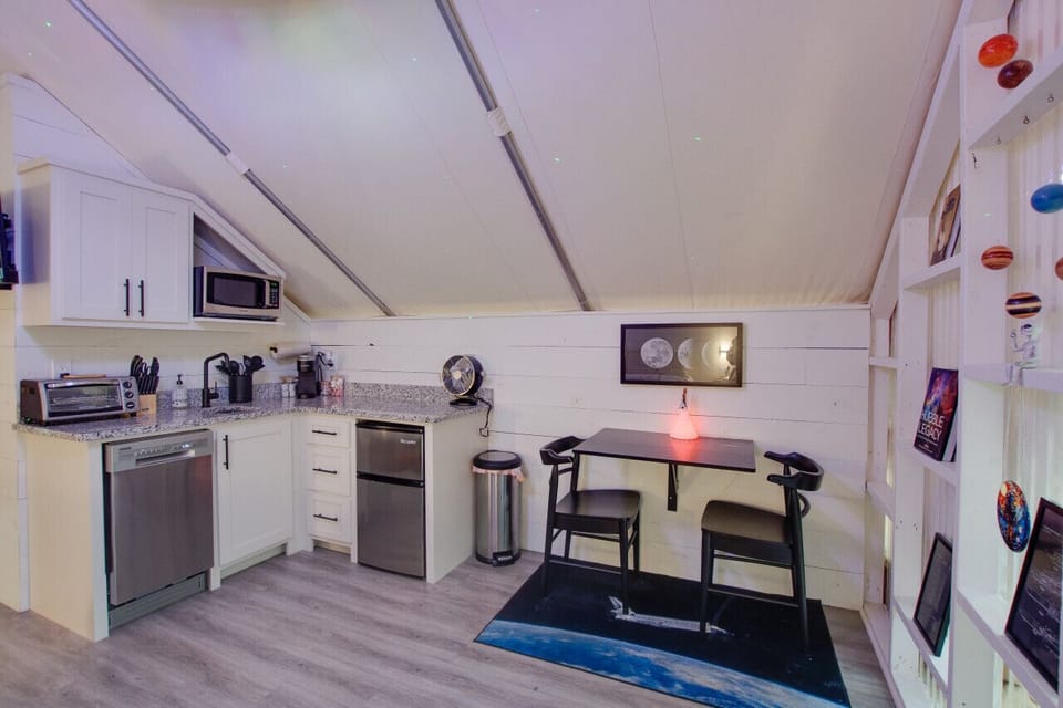 Glamping tent with a tasteful and fun décor, dining space for a meal in, perfect for fun-filled evenings and relaxation in nature.