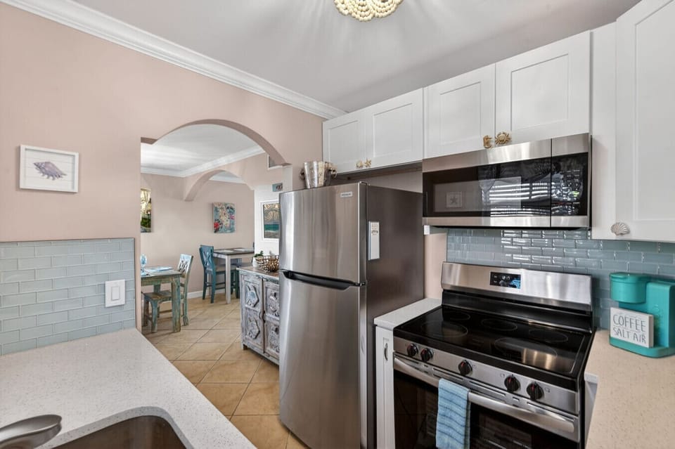 Well-equipped kitchen w/ stove, fridge & clean lines for easy cooking.
