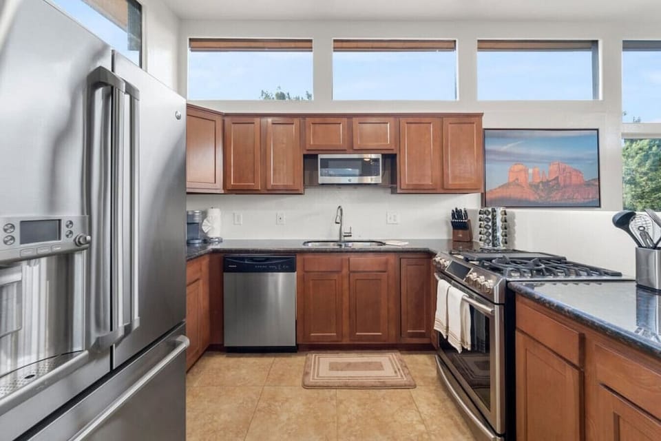 Open kitchen area has several windows for excellent natural lighting