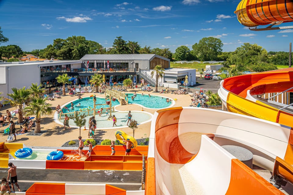 Experience the thrill of family fun at Riez à la Vie, where colorful water slides and a vibrant pool area create the perfect paradise for kids and adults alike.