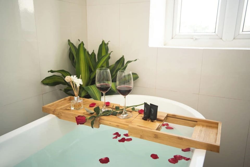 Shower, designer toiletries, hair dryer, slippers