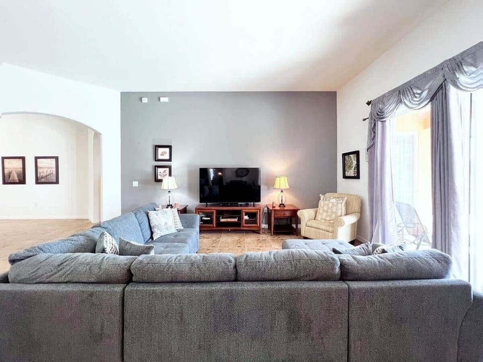 Gather in the inviting living room with comfortable furnishings, a large flat-screen TV, and complimentary high-speed Wi-Fi for entertainment and relaxation.