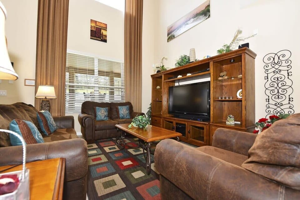 Gather in the inviting living room with comfortable furnishings, a large flat-screen TV, and complimentary high-speed Wi-Fi for entertainment and relaxation.