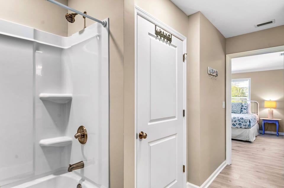Attached bath, shower/tub combo; there is an additional half bath on this floor