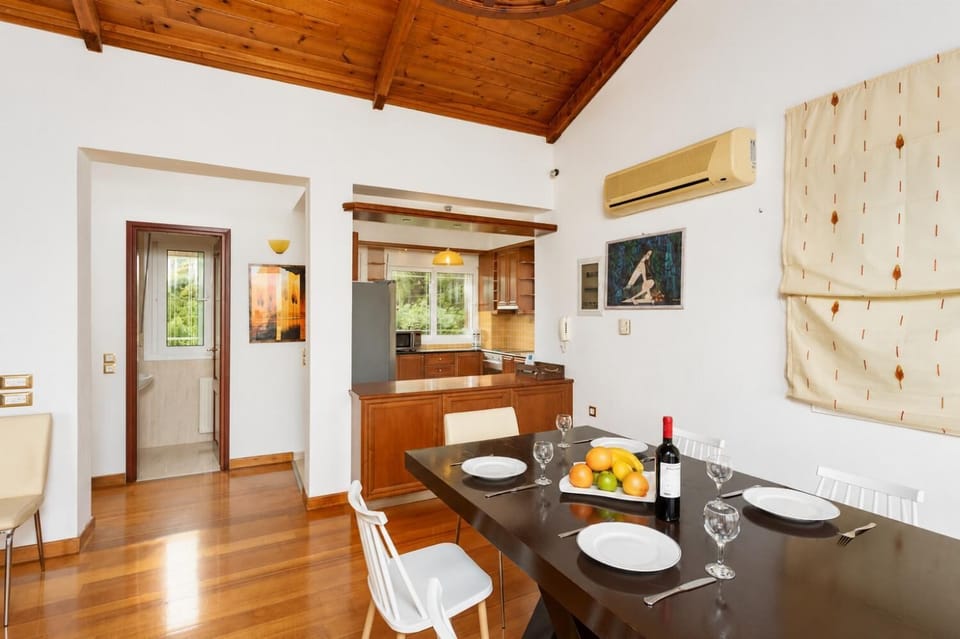 Open-plan living room with sofa, dining area, kitchen, ornamental fireplace, A/C, WiFi internet, satellite TV, and sea views