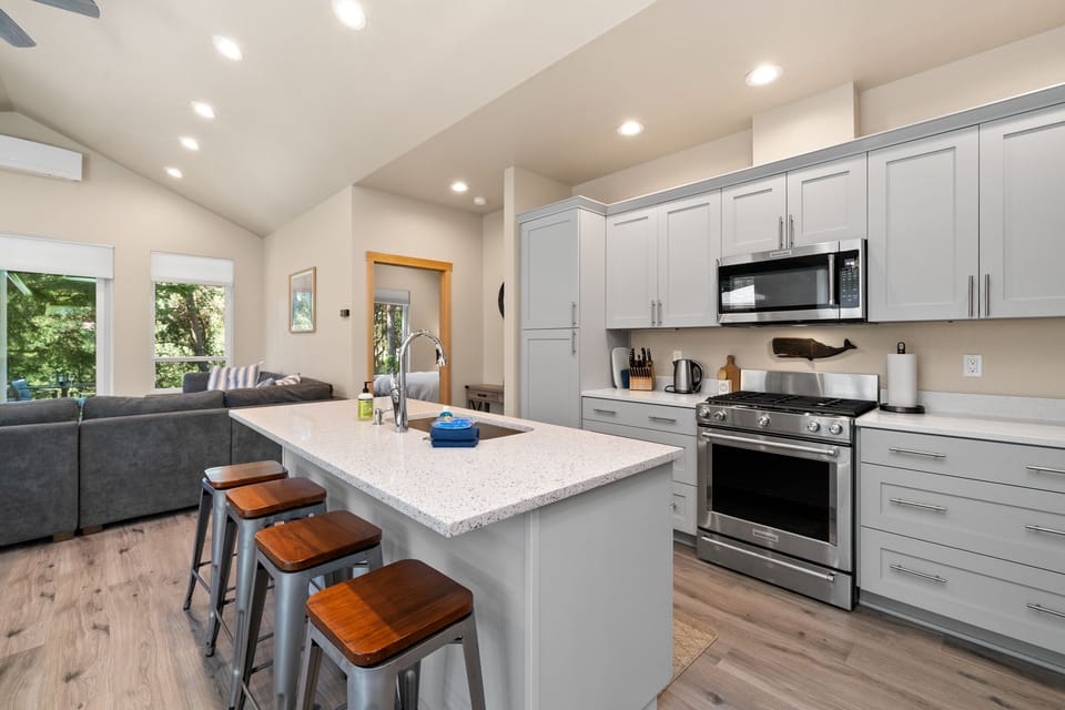 Beautiful kitchen with all new appliances, Gas range, dishwasher, Fridge, microwave, and breakfast bar.