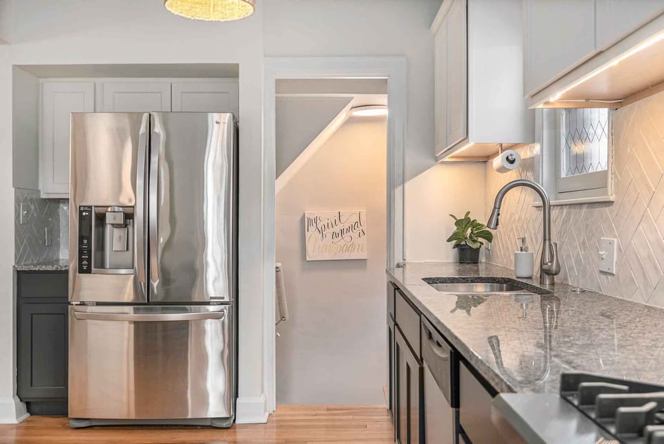 A stairwell in the kitchen leads to the downstairs living space