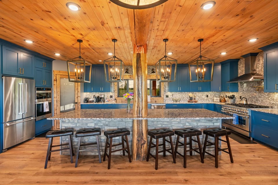 A chef's kitchen is fully equipped with high-end appliances and three ovens.