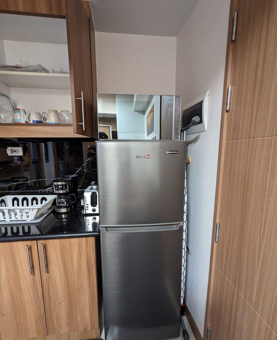 Refrigerator with the Microwave on top of it