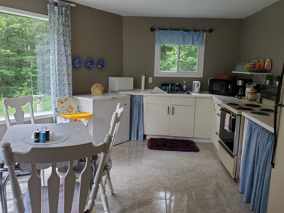 Full kitchen - stove, fridge, microwave, toaster, kettle, coffee maker, dishes.