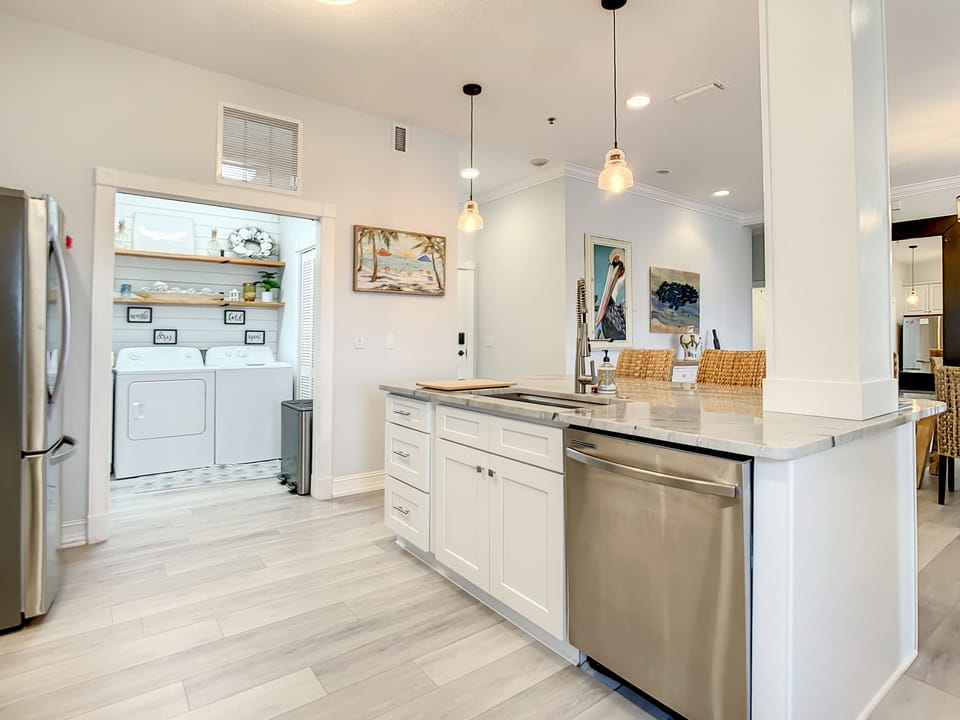 Kitchen details - all stainless steel appliances + alcove area with washer/dryer