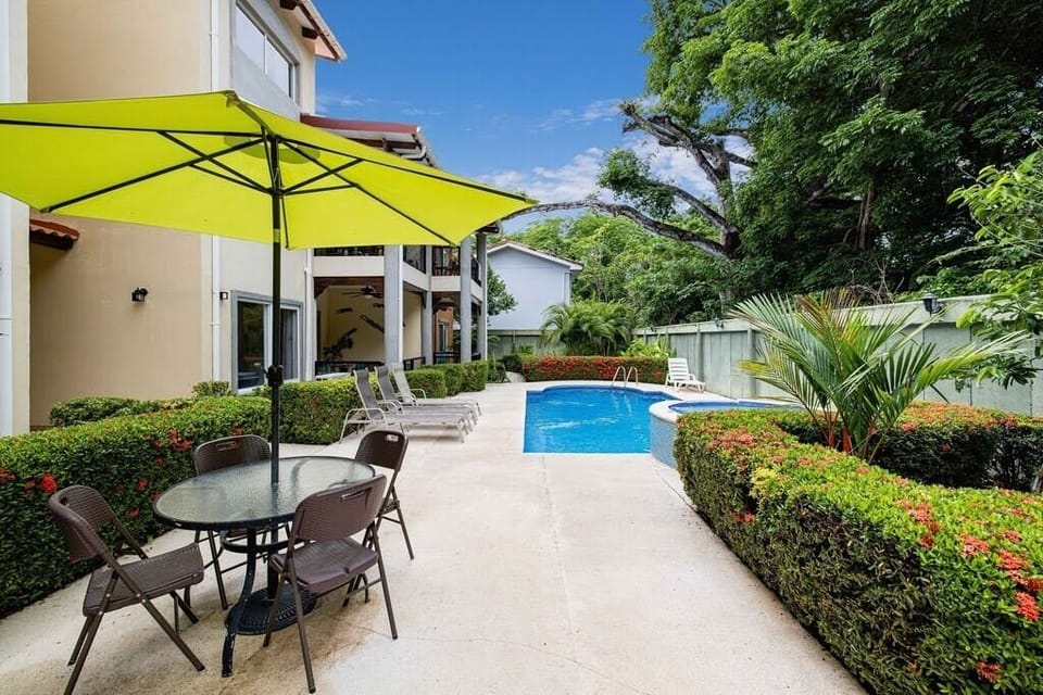 Tended gardens and ample seating for long days by the pool.