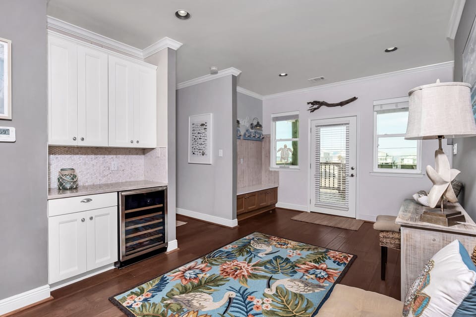 bar off the dining area with a wine cooler