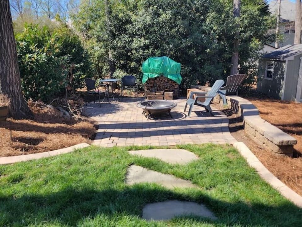 14"x14" paver patio with firepit/firewood and seating wall.