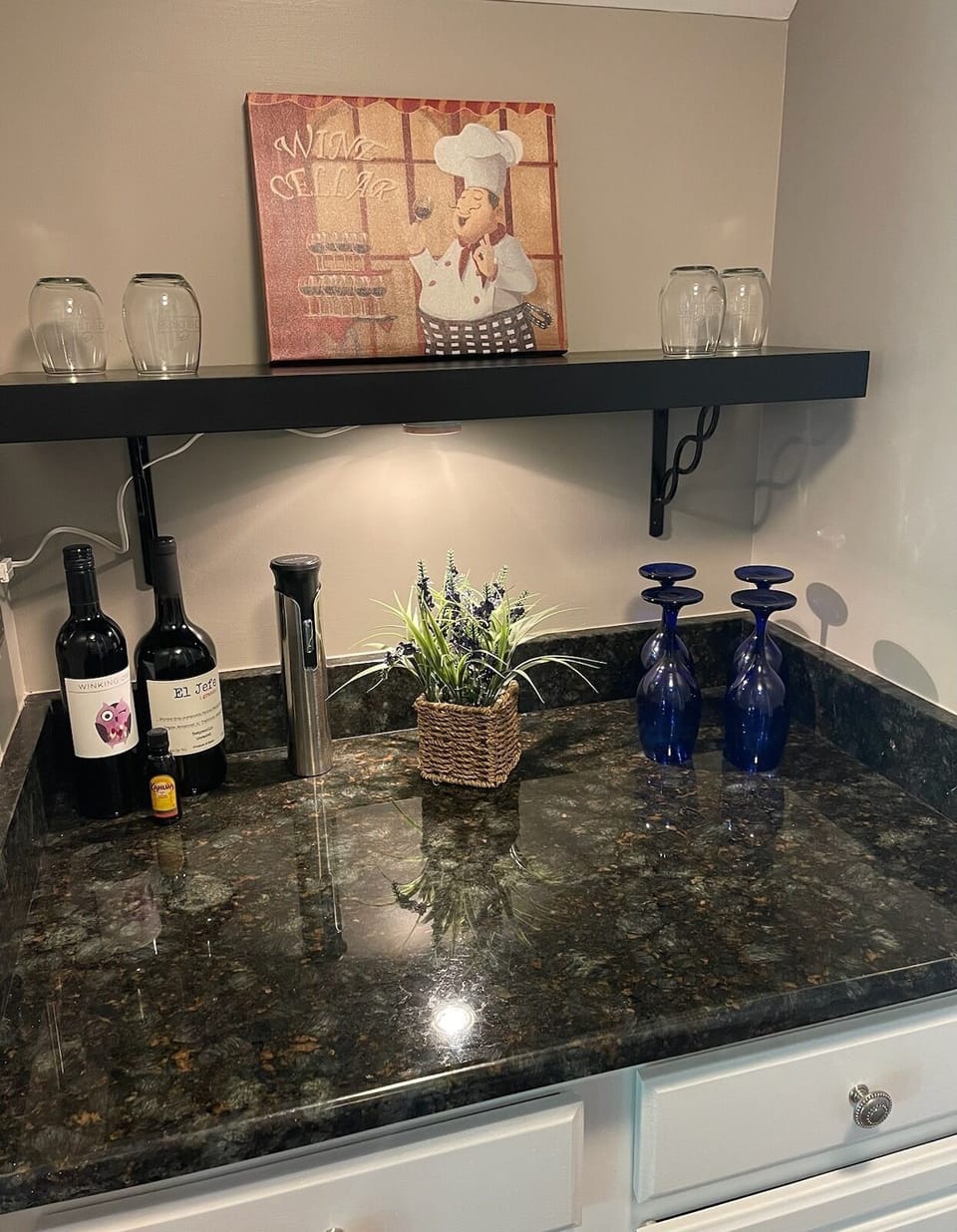 Butler pantry located between living room and dining room. Wine glasses/opener.