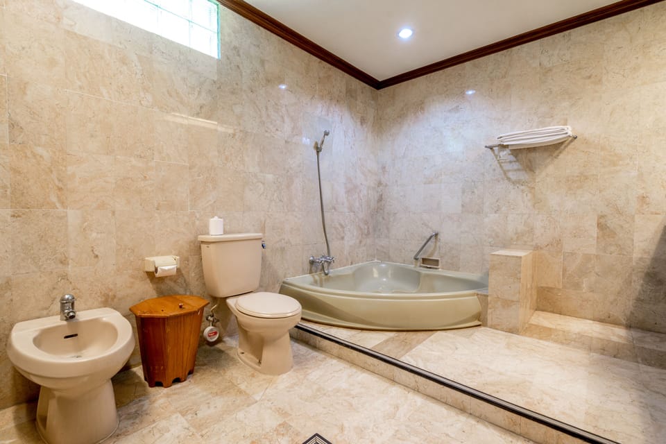 Suite, Garden View | Bathroom | Combined shower/tub, deep soaking tub, free toiletries, hair dryer
