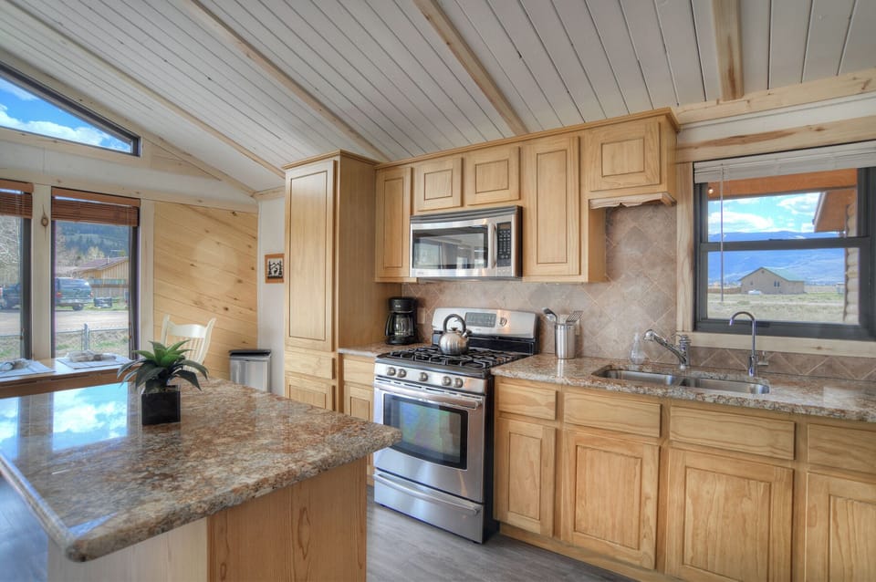 Kitchen Warrick Cabin VRC Rental Home - Fully equipped kitchen with granite countertops and gas range.