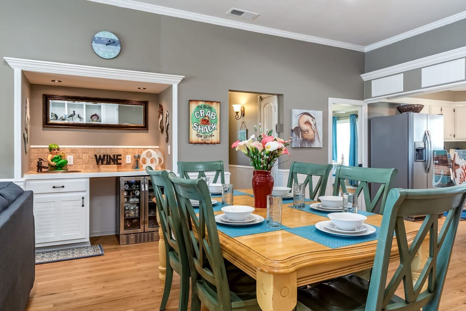 Gather around your charming dining table for memorable meals, complete with a stylish wet bar perfect for evening cocktails.