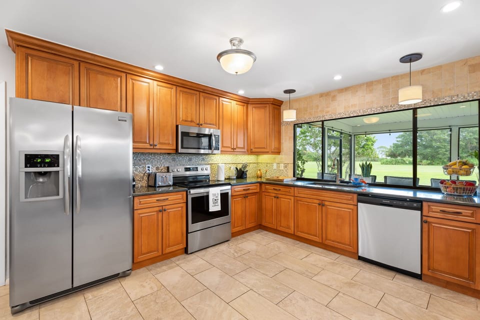 Open-Concept Luxury Dining with Golf Views and Gourmet Kitchen