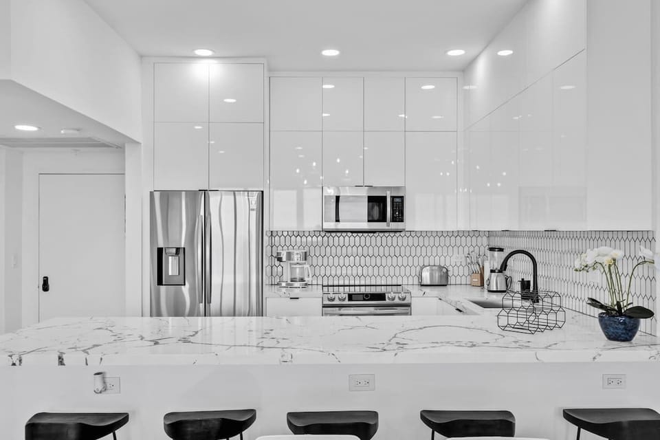Luxury kitchen with marble island! Cook, sip, and relax in this sleek space with designer finishes.