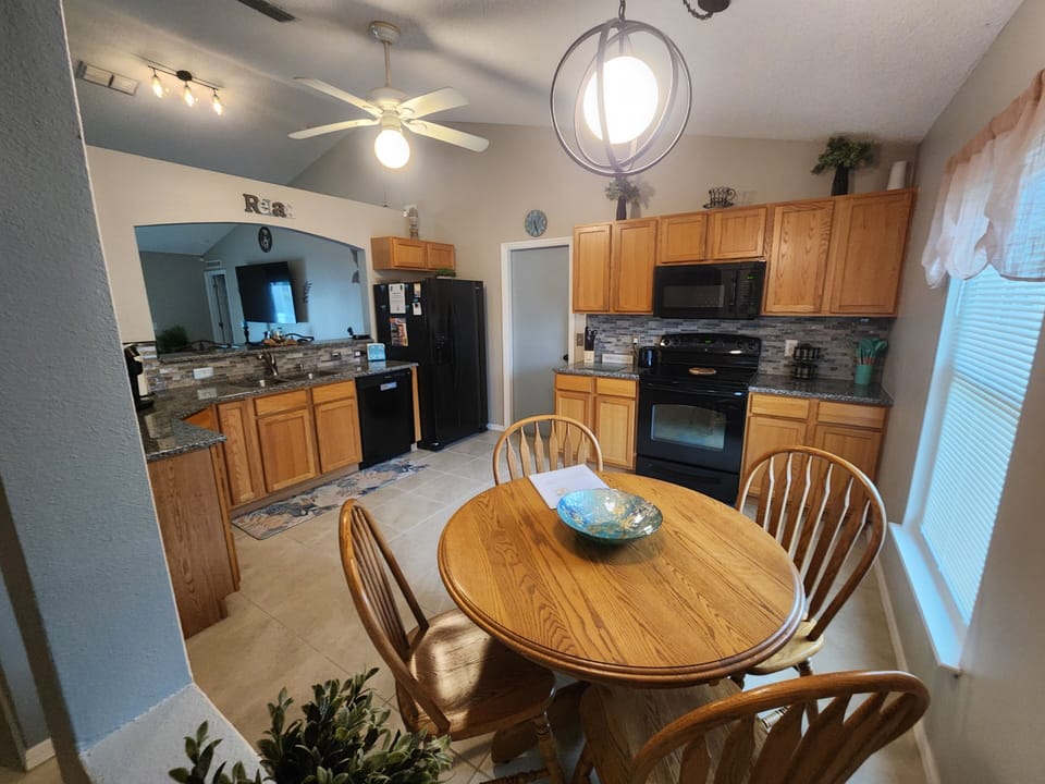 Kitchen, table seats 4 and there are 2 more seating spaces at the breakfast bar.