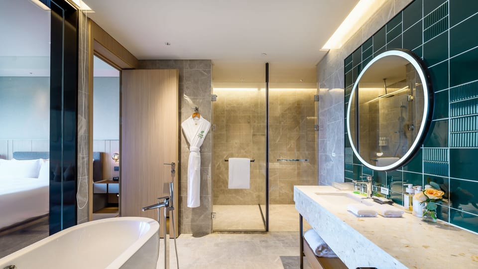 Suite, 1 King Bed | Bathroom | Separate tub and shower, rainfall showerhead, free toiletries