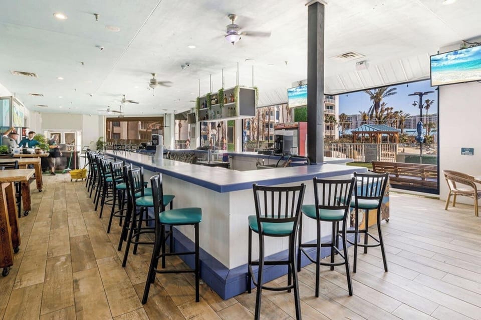 Open-air bar area on-site w/ plenty of seating, TVs, & a laid-back coastal vibe